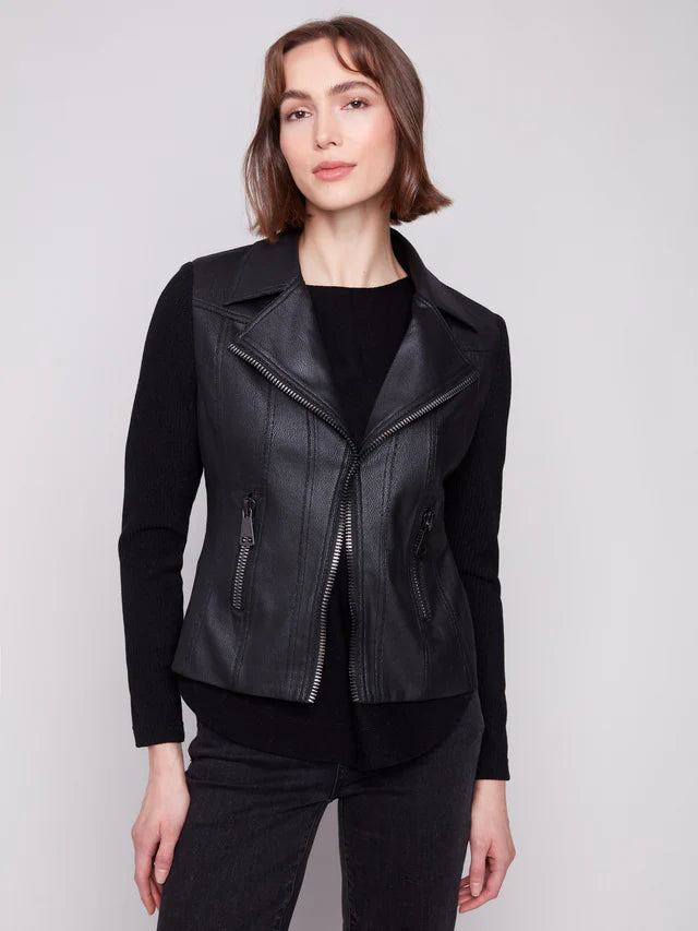 Woman wearing a black leather jacket on a plain background